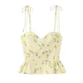 Primer plano de un top corsé con estampado floral amarillo y lazos en los hombros - XS / Tops / Amarillo