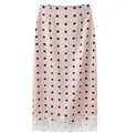 Close-up of pink polka dot midi skirt featuring elegant white lace patchwork at the hem - S / Bottoms / Pink