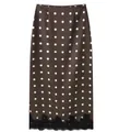 Elegant brown midi skirt featuring white polka dots and a delicate black lace trim detail - Brown