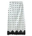 Detailed view of the black lace hem and polka dot pattern on a white midi skirt - White