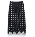 Detailed view of black polka dot midi skirt featuring white floral lace hem trim - S / Bottoms / Black