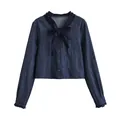 Detail of dark blue denim short top featuring ruffle neck and decorative bow - S / Tops