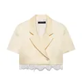 Detailed view of the cream short-sleeved cropped blazer with white lace patchwork hem - XS / Tops / Milk Yellow