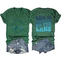 Detail view showing the front and back graphic prints of the "Life is better at the lake" tee. - Vintage Green