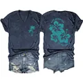 Detail view of navy V-neck tee with palm tree and hibiscus print paired with denim shorts. - Navy Blue