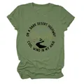 Gros plan d'un t-shirt vert avec un imprimé graphique de route de désert sombre - S / Hauts / Vert olive