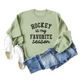 Detailed flat lay of sage green hockey sweatshirt paired with denim jeans and white shoes. - Olive Green (Black Print)