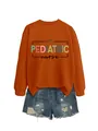 Detailed view of pediatric nurse graphic print on comfortable rust orange sweatshirt - S / Tops / Rust Orange (Black Graphic)