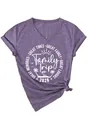 Detalle del estampado Family Trip 2026 en camiseta morada de cuello de pico y corte holgado - Morado (Fuente Blanca)