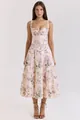 Front view of a pink floral midi dress with a corset bodice on a model in studio - Peach