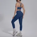 Detail view of navy blue yoga set with cross-back sports bra and high waist leggings. - S / Top And Bottom / Navy Blue