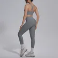 Back view of a grey seamless yoga set with a criss-cross sports bra and leggings - Titanium Gray