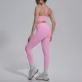 Detailed back view of pink cross-strap sports bra and high-waisted yoga leggings set - Sakura Pink
