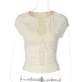 Front view detail of ruched cream t-shirt with tie-neck and cutout - S / Tops / Apricot