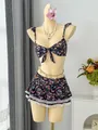 Close-up of a floral bikini set featuring ruffled straps and a lace-trimmed skirted bottom. - S / Top And Bottom / Black