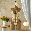 Elegant close-up of gold sequin floral embroidery on a cream ruffled vacation bikini set - S / Top And Bottom / Coffee Ethnic Pattern
