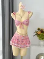 Detailed view of pink floral ruffled bikini set with lace-trimmed skirt on mannequin - S / Top And Bottom / Pink