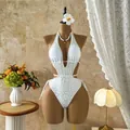 Detailed view of white leopard print one-piece swimsuit featuring sexy waist cutout and halter neck - XS / Tops / White