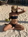 Young woman in stylish black studded bikini and straw hat sitting on sandy tropical beach - S / Top And Bottom / Black
