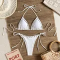 Flat lay detail of a white rivet bikini set with halter neck and tie-side bottom design - S / Top And Bottom / White