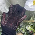 Close-up detail of delicate black floral lace pattern on mesh socks for young girls - Ages 8-10 / Daisy Flower Style / Black