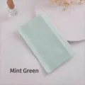 Detailansicht der dünnen minzgrünen Strumpfhose in minimalistischer transparenter Verpackung - Minzgrün