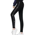 Detail view of side rhinestone 'LOVE' lettering on black seamless fleece leggings - LOVE Letter Rhinestone