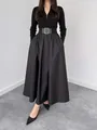 Front view of an elegant black long-sleeved dress featuring a cinched belted waist - S / Tops / Black
