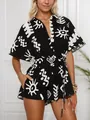 Close-up of women's short sleeve belted romper with black and white abstract sun print - S / Top And Bottom / Black