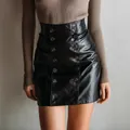 Detailed view of a black double-breasted PU leather mini skirt with bodycon fit - S / Black