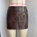 Macro view of vintage brown faux leather mini skirt featuring double decorative buckles - S / Bottoms / Brown
