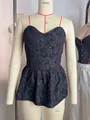 Detailed view of black jacquard peplum top with sweetheart neckline on mannequin - S / Tops / Black