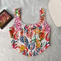 Detailed view of vibrant paisley print and structural seams on slim fit corset top - XS / Tops / Red