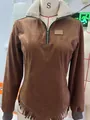 Detailed macro view of brown suede long-sleeve top with white fur collar and fringe hem - S / Tops / Dark Brown