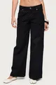 Detalle de vaqueros negros de pierna ancha con lunares combinados con zapatos planos blancos - S / Bottoms / Negro