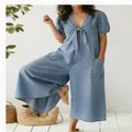 Detailed view of women's casual washed denim jumpsuit with V-neck tie and wide leg - S / Top And Bottom / Light Blue