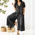 Washed black denim jumpsuit for women featuring a stylish V-neck and tie-front design - 3XL / Top And Bottom / Black
