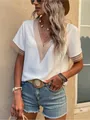 Detailed shot of white satin blouse with lace trim V-neck and casual short sleeves - S / Tops / White
