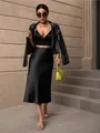 Elegant black satin midi skirt with a high waist, paired with a matching top and jacket. - S / Bottoms / Black