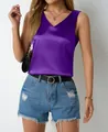 Elegant purple satin V-neck tank top styled with denim shorts and a belt. - Purple