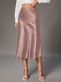 Close-up detail showing the smooth satin texture and elegant drape of the rose gold skirt - Lotus Pink