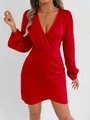 Close-up of elegant red satin mini dress with deep V-neck and long puff sleeves - Red