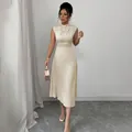 Elegant champagne satin midi dress featuring a pleated neckline and classic A-line silhouette - S / Top And Bottom / Apricot