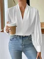 Close-up detail of white satin V-neck blouse with elegant puff sleeves for women - White