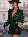 Fashion model posing in a vibrant green leopard print satin shirt and black leather shorts - XS / Tops / Green