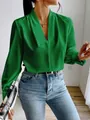 Detail of a green satin V-neck blouse with elegant pleats and long sleeves for women. - Green