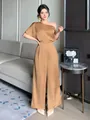 Elegant satin asymmetrical wide-leg jumpsuit shown on an Asian model in a modern room - S / Top And Bottom / Khaki