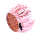 Detail showing the adjustable black elastic strap on a pink satin sleeping cap. - One Size / Pink