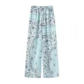 Detailed macro view of stylish light blue paisley print wide leg trousers for women - S / Bottoms / Light Lake Blue