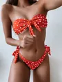Detail eines roten Polka-Dot-Bikinis mit Bandeau-Oberteil und seitlichen Schleifen - S / Oberteil Und Unterteil / Rot Gepunktet